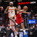 Oct 16, 2025; Atlanta, Georgia, USA; Atlanta Hawks guard Nickeil Alexander-Walker (7) is fouled by Houston Rockets guard Reed Sheppard (15) during the first half at State Farm Arena.
