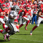 Oct 19, 2025; Kansas City, Missouri, USA; Kansas City Chiefs safety Jaden Hicks (21) tackles Las Vegas Raiders running back Ashton Jeanty (2) during the fourth quarter of the game at GEHA Field at Arrowhead Stadium. Mandatory Credit: Denny Medley-Imagn Images