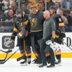 Oct 20, 2025; Las Vegas, Nevada, USA; Vegas Golden Knights goaltender Adin Hill (33) is helped off the ice after sustaining an injury playing against the Carolina Hurricanes during the first period at T-Mobile Arena. Mandatory Credit: Stephen R. Sylvanie-Imagn Images