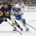 Oct 27, 2025; Pittsburgh, Pennsylvania, USA; St. Louis Blues center Brayden Schenn (10) skates with the puck against pressure from Pittsburgh Penguins center Connor Dewar (19) during the first period at PPG Paints Arena. Mandatory Credit: Charles LeClaire-Imagn Images