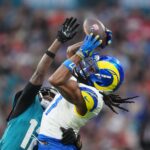 Oct 19, 2025; London, United Kingdom; Los Angeles Rams wide receiver Davante Adams (17) makes a catch against Jacksonville Jaguars wide receiver Travis Hunter (12) during the second half of an NFL International Series game at Wembley Stadium