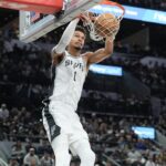 Jan 17, 2025; San Antonio, Texas, USA; San Antonio Spurs center Victor Wembanyama (1) dunks the ball in front of Memphis Grizzlies forward Jaylen Wells (0) in the second half at Frost Bank Center.