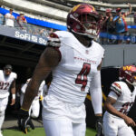 Oct 5, 2025; Inglewood, California, USA; Washington Commanders linebacker Frankie Luvu (4) runs on field before the game against the Los Angeles Chargers at SoFi Stadium. Mandatory Credit: Jayne Kamin-Oncea-Imagn Images