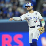 Nov 1, 2025; Toronto, Ontario, CAN; Toronto Blue Jays designated hitter Bo Bichette (11) throws to first for an out against Los Angeles Dodgers second baseman Tommy Edman (25) in the eighth inning during game seven of the 2025 MLB World Series at Rogers Centre. Mandatory Credit: John E. Sokolowski-Imagn Images