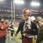 Nov 2, 2025; Landover, Maryland, USA; Washington Commanders quarterback Jayden Daniels (5) is helped off the field after an injury during the second half against the Seattle Seahawks at Northwest Stadium. Mandatory Credit: Amber Searls-Imagn Images