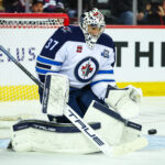 Nov 15, 2025; Calgary, Alberta, CAN; Winnipeg Jets goaltender Connor Hellebuyck (37) makes a save against the Calgary Flames during the second period at Scotiabank Saddledome. Mandatory Credit: Sergei Belski-Imagn Images