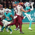 Nov 16, 2025; Madrid, Spain; Miami Dolphins cornerback Jack Jones (23) interception a pass intended for Washington Commanders tight end Zach Ertz (86) in overtime during the 2025 NFL Madrid Game at Santiago Bernabeu Stadium. Mandatory Credit: Kirby Lee-Imagn Images