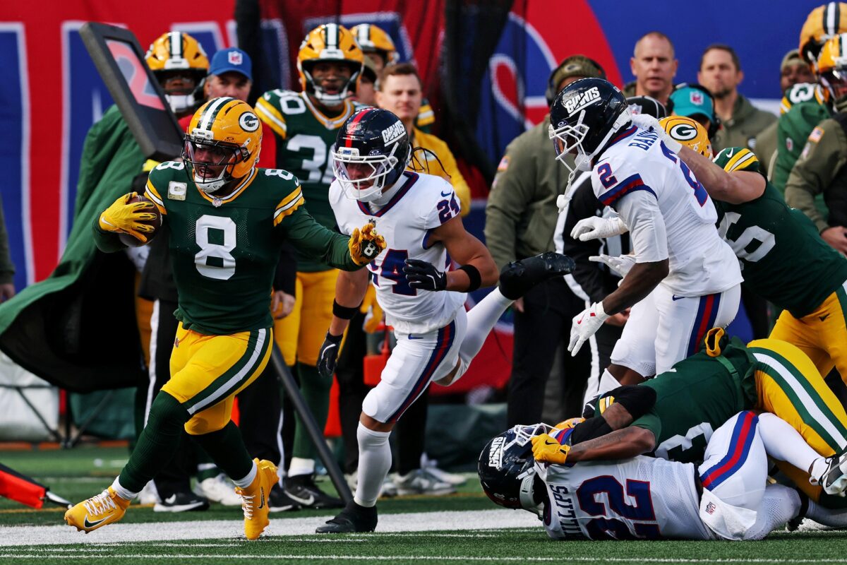 Nov 16, 2025; East Rutherford, New Jersey, USA; Green Bay Packers running back Josh Jacobs (8) runs the ball against New York Giants safety Dane Belton (24) during the first quarter at MetLife Stadium. Mandatory Credit: Vincent Carchietta-Imagn Images
