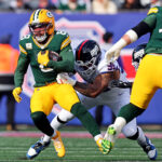 Nov 16, 2025; East Rutherford, New Jersey, USA; Green Bay Packers running back Josh Jacobs (8) runs the ball against New York Giants defensive tackle Roy Robertson-Harris (95) during the first quarter at MetLife Stadium. Mandatory Credit: Vincent Carchietta-Imagn Images