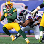 Nov 16, 2025; East Rutherford, New Jersey, USA; Green Bay Packers running back Josh Jacobs (8) runs the ball against New York Giants defensive tackle Roy Robertson-Harris (95) during the first quarter at MetLife Stadium. Mandatory Credit: Vincent Carchietta-Imagn Images