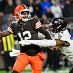 Nov 16, 2025; Cleveland, Ohio, USA; Cleveland Browns quarterback Shedeur Sanders (12) is sacked by Baltimore Ravens linebacker Trenton Simpson (32) during the fourth quarter at Huntington Bank Field. Mandatory Credit: Ken Blaze-Imagn Images