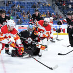 Nov 19, 2025; Buffalo, New York, USA; Buffalo Sabres defenseman Rasmus Dahlin (26) and Calgary Flames left wing Joel Farabee (86) with center Nazem Kadri (91) go for the puck in front of Buffalo Sabres goaltender Colten Ellis (92) in the third period at KeyBank Center. Mandatory Credit: Mark Konezny-Imagn Images