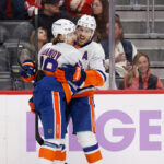 Nov 20, 2025; Detroit, Michigan, USA; New York Islanders right wing Max Shabanov (49) receives congratulations from New York Islanders defenseman Ryan Pulock (6) after scoring in the third period against the Detroit Red Wings at Little Caesars Arena. Mandatory Credit: Rick Osentoski-Imagn Images