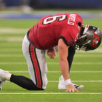 Nov 23, 2025; Inglewood, California, USA; Tampa Bay Buccaneers quarterback Baker Mayfield (6) kneels on the field with an apparent injury against the Los Angeles Rams during the second quarter at SoFi Stadium. Mandatory Credit: Jayne Kamin-Oncea-Imagn Images
