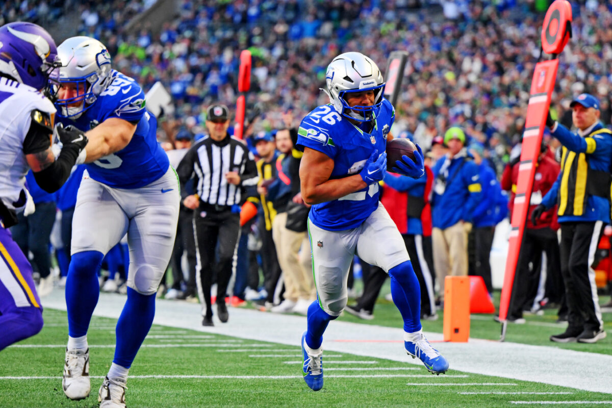 Nov 30, 2025; Seattle, Washington, USA; Seattle Seahawks running back Zach Charbonnet (26) scores a touchdown during the second half against the Minnesota Vikings at Lumen Field. Mandatory Credit: Steven Bisig-Imagn Images