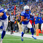 Nov 30, 2025; Seattle, Washington, USA; Seattle Seahawks running back Zach Charbonnet (26) scores a touchdown during the second half against the Minnesota Vikings at Lumen Field. Mandatory Credit: Steven Bisig-Imagn Images