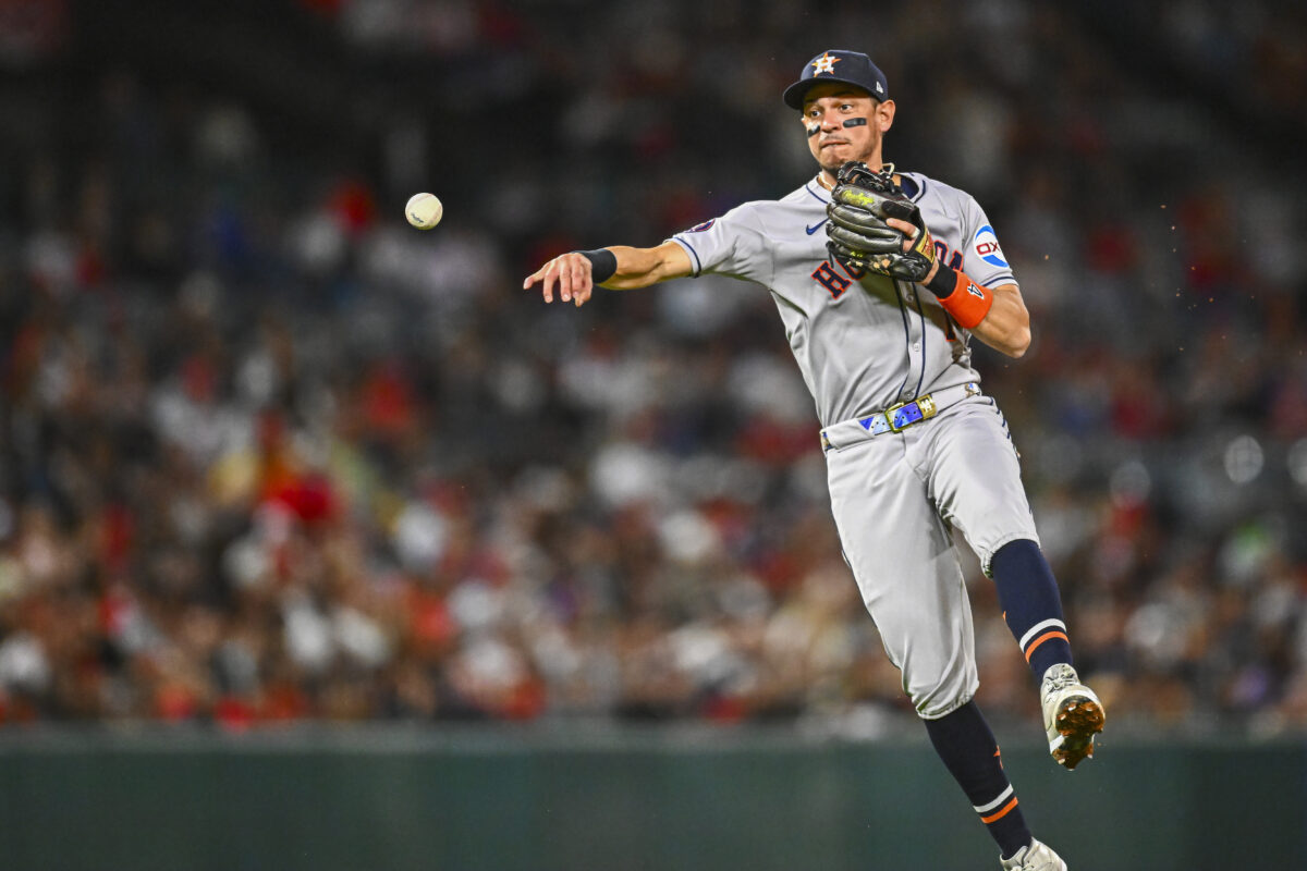 Sep 27, 2025; Anaheim, California, USA; Houston Astros shortstop Mauricio Dubón (14) throws to first base to force an out against the Los Angeles Angels during the fifth inning at Angel Stadium.