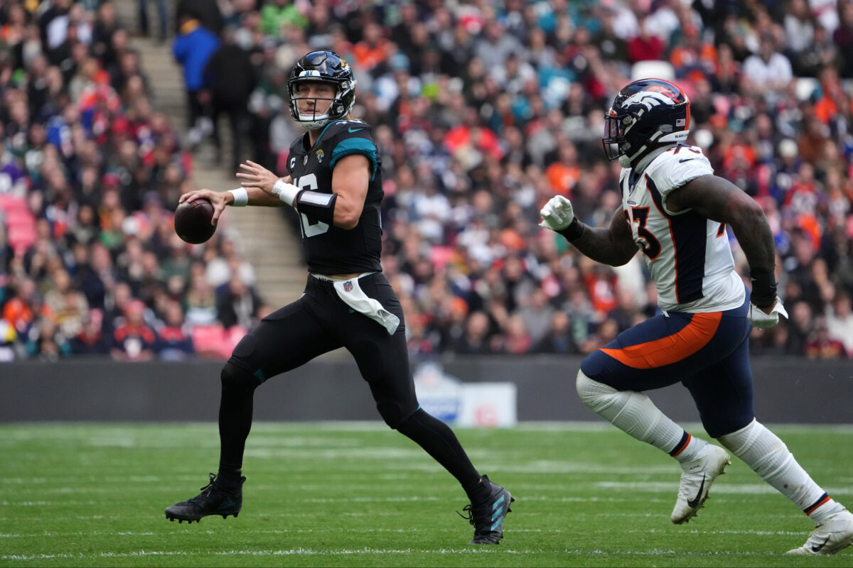 Oct 30, 2022; London, United Kingdom; Jacksonville Jaguars quarterback Trevor Lawrence (16) throws the ball in the first half against under pressure from Denver Broncos defensive end Dre'Mont Jones (93) during an NFL International Series game at Wembley Stadium. Mandatory Credit: Kirby Lee-USA TODAY Sports