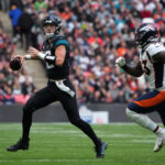 Oct 30, 2022; London, United Kingdom; Jacksonville Jaguars quarterback Trevor Lawrence (16) throws the ball in the first half against under pressure from Denver Broncos defensive end Dre'Mont Jones (93) during an NFL International Series game at Wembley Stadium. Mandatory Credit: Kirby Lee-USA TODAY Sports
