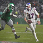 NFL Nov 26, 2023; Philadelphia, Pennsylvania, USA; Buffalo Bills quarterback Josh Allen (17) scrambles away from Philadelphia Eagles defensive tackle Jordan Davis (90) during overtime at Lincoln Financial Field. Mandatory Credit: Eric Hartline-USA TODAY Sports