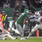 Nov 26, 2023; Philadelphia, Pennsylvania, USA; Philadelphia Eagles quarterback Jalen Hurts (1) scores the game-winning touchdown on a 12-yard run in overtime against Buffalo Bills safety Micah Hyde (23) and cornerback Rasul Douglas (31) at Lincoln Financial Field. Mandatory Credit: Eric Hartline-USA TODAY Sports