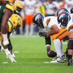 Aug 18, 2024; Denver, Colorado, USA; Denver Broncos center Sam Mustipher (61) snaps the ball in the second quarter against the Green Bay Packers at Empower Field at Mile High. Mandatory Credit: Ron Chenoy-USA TODAY Sports