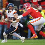 Nov 10, 2024; Kansas City, Missouri, USA; Denver Broncos quarterback Bo Nix (10) is sacked by Kansas City Chiefs defensive end Felix Anudike-Uzomah (97) at GEHA Field at Arrowhead Stadium. Mandatory Credit: Jay Biggerstaff-Imagn Images