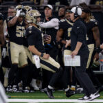 Aug 23, 2025; New Orleans, Louisiana, USA; New Orleans Saints quarterback Tyler Shough (6) runs out of bounds next to New Orleans Saints head coach Kellen Moore against the Denver Broncos during the first half at Caesars Superdome. Mandatory Credit: Matthew Hinton-Imagn Images