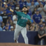 Oct 19, 2025; Toronto, Ontario, CAN; Seattle Mariners third baseman Eugenio Suarez (28) attempts a throw to first against the Toronto Blue Jays in the second inning during game six of the ALCS round for the 2025 MLB playoffs at Rogers Centre. Mandatory Credit: John E. Sokolowski-Imagn Images