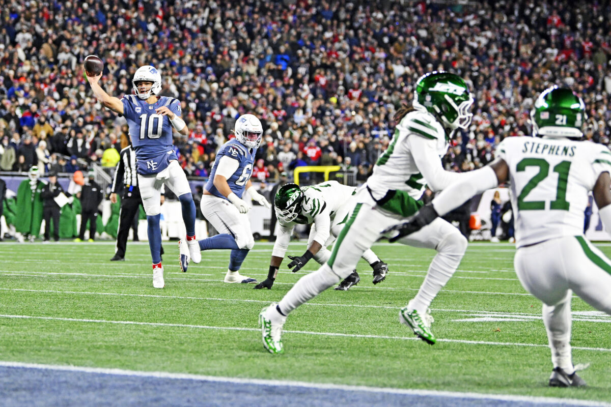 Nov 13, 2025; Foxborough, Massachusetts, USA; New England Patriots quarterback Drake Maye (10) throws a touchdown pass to New England Patriots running back TreVeyon Henderson (32) during the first half at Gillette Stadium. Mandatory Credit: Eric Canha-Imagn Images