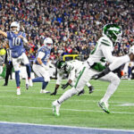 Nov 13, 2025; Foxborough, Massachusetts, USA; New England Patriots quarterback Drake Maye (10) throws a touchdown pass to New England Patriots running back TreVeyon Henderson (32) during the first half at Gillette Stadium. Mandatory Credit: Eric Canha-Imagn Images