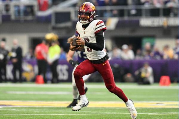 Dec 7, 2025; Minneapolis, Minnesota, USA; Washington Commanders quarterback Jayden Daniels (5) rushes the ball against the Minnesota Vikings during the first half at U.S. Bank Stadium. Mandatory Credit: Jeffrey Becker-Imagn Images