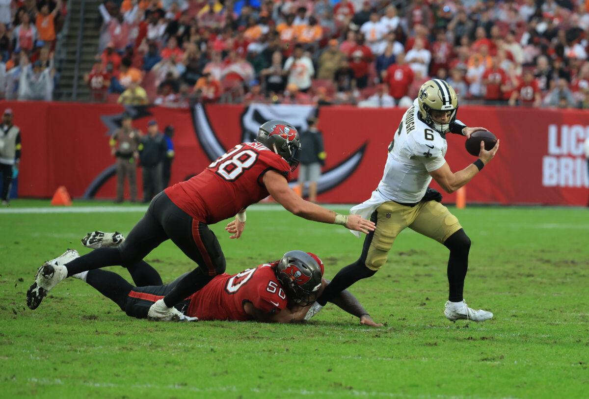 Dec 7, 2025; Tampa, Florida, USA; New Orleans Saints quarterback Tyler Shough (6) runs for a gain past Tampa Bay Buccaneers linebacker Anthony Nelson (98) and defensive tackle Vita Vea (50) during the fourth quarter at Raymond James Stadium. Mandatory Credit: Kim Klement Neitzel-Imagn Images
