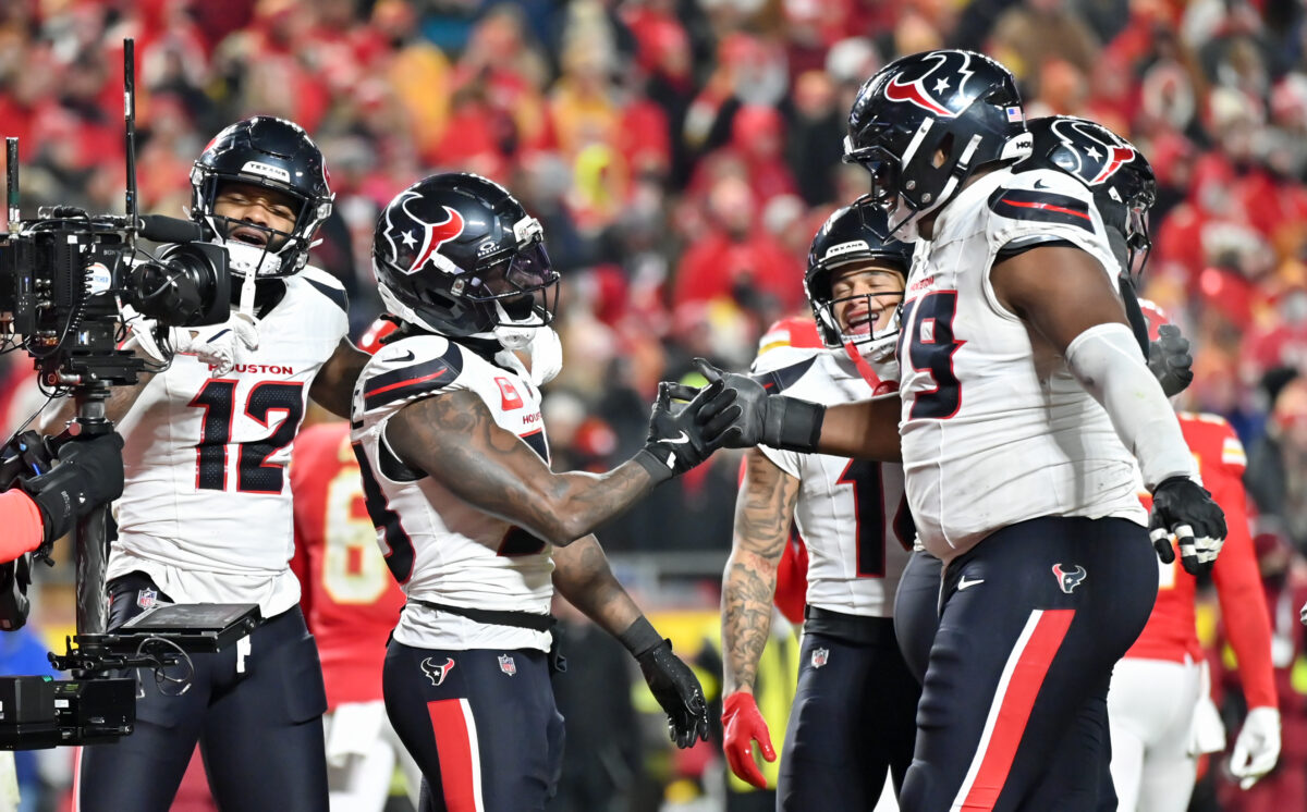 Dec 7, 2025; Kansas City, Missouri, USA; Houston Texans wide receiver Nico Collins (12) and Houston Texans running back Dare Ogunbowale (33) celebrate after a touchdown during the fourth quarter against the Kansas City Chiefs at GEHA Field at Arrowhead Stadium. Mandatory Credit: Amy Kontras-Imagn Images