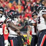 Dec 7, 2025; Kansas City, Missouri, USA; Houston Texans wide receiver Nico Collins (12) and Houston Texans running back Dare Ogunbowale (33) celebrate after a touchdown during the fourth quarter against the Kansas City Chiefs at GEHA Field at Arrowhead Stadium. Mandatory Credit: Amy Kontras-Imagn Images