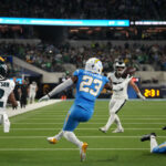 Dec 8, 2025; Inglewood, California, USA; Los Angeles Chargers safety Tony Jefferson (23) intercepts the ball against Philadelphia Eagles wide receiver Jahan Dotson (2) in overtime at SoFi Stadium. Mandatory Credit: Kirby Lee-Imagn Images