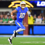 Dec 8, 2025; Inglewood, California, USA; Los Angeles Chargers quarterback Justin Herbert (10) runs against the Philadelphia Eagles in the second half at SoFi Stadium. Mandatory Credit: Gary A. Vasquez-Imagn Images