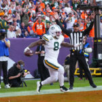 Dec 14, 2025; Denver, Colorado, USA; Green Bay Packers running back Josh Jacobs (8) reacts after a touchdown during the second quarter against the Denver Broncos at Empower Field at Mile High. Mandatory Credit: Ron Chenoy-Imagn Images