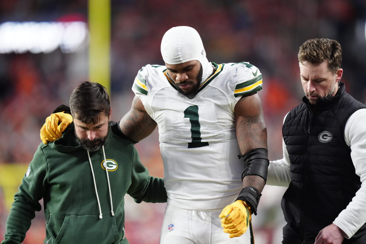 Dec 14, 2025; Denver, Colorado, USA; Green Bay Packers defensive end Micah Parsons (1) walks off the field with help from medical personnel following an injury during the third quarter against the Denver Broncos at Empower Field at Mile High. Mandatory Credit: Ron Chenoy-Imagn Images
