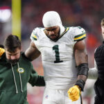 Dec 14, 2025; Denver, Colorado, USA; Green Bay Packers defensive end Micah Parsons (1) walks off the field with help from medical personnel following an injury during the third quarter against the Denver Broncos at Empower Field at Mile High. Mandatory Credit: Ron Chenoy-Imagn Images