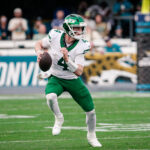 Dec 14, 2025; Jacksonville, Florida, USA;New York Jets quarterback Brady Cook (4) scrambles against the Jacksonville Jaguars at EverBank Stadium. Mandatory Credit: Travis Register-Imagn Images