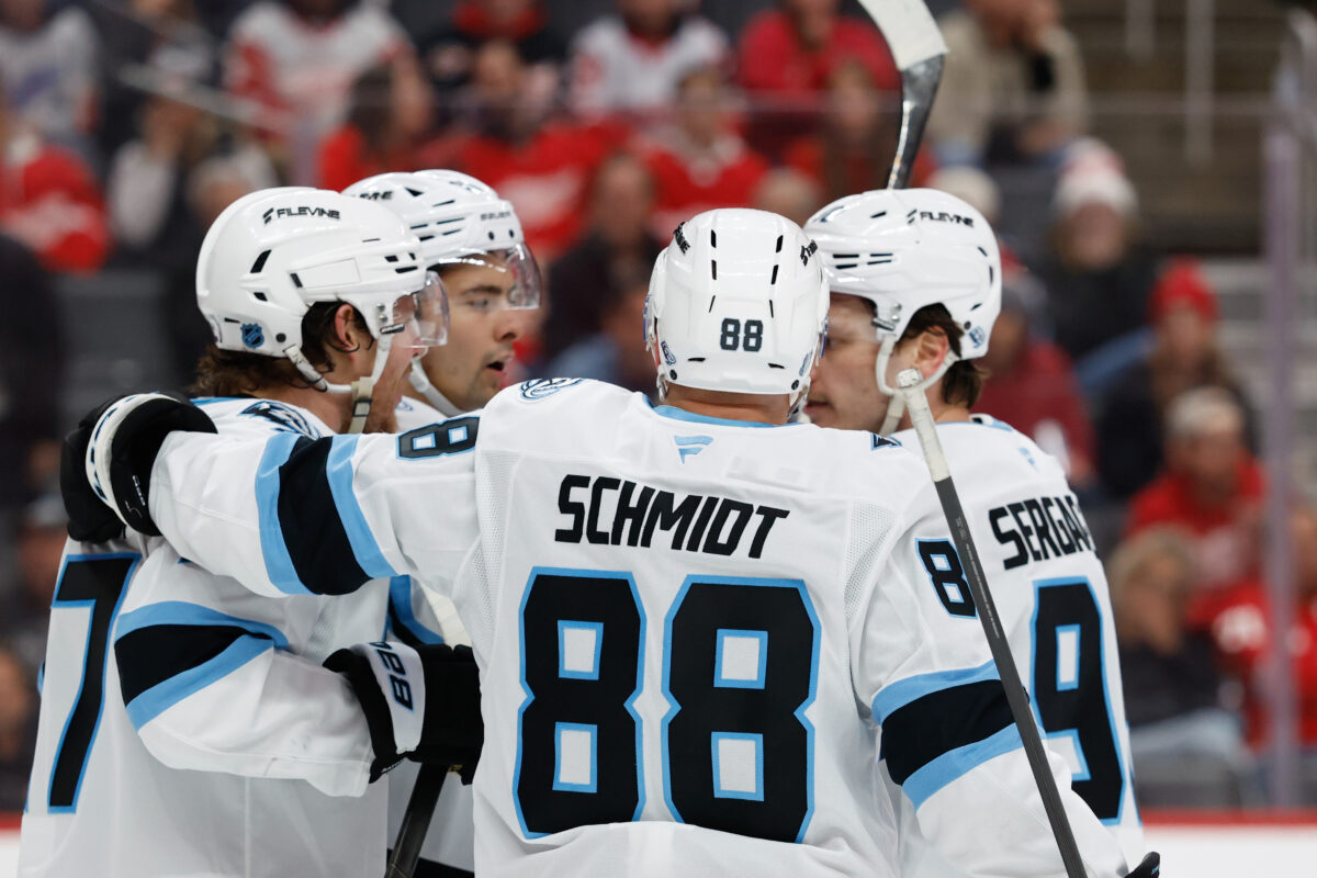 Dec 17, 2025; Detroit, Michigan, USA; Utah Mammoth right wing Dylan Guenther (11) receives congratulations from teammates after scoring in the third period against the Detroit Red Wings at Little Caesars Arena. Mandatory Credit: Rick Osentoski-Imagn Images