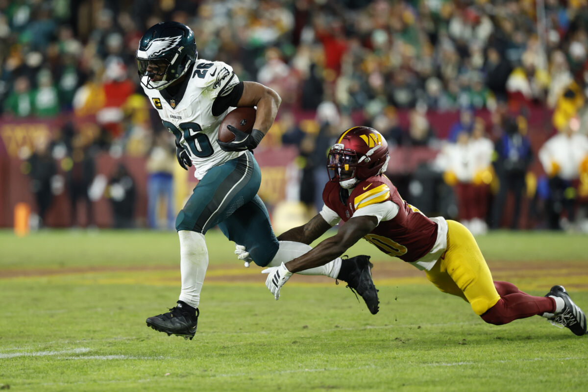 Dec 20, 2025; Landover, Maryland, USA; Philadelphia Eagles running back Saquon Barkley (26) runs against Washington Commanders safety Quan Martin (20) at Northwest Stadium. Mandatory Credit: Geoff Burke-Imagn Images