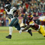 Dec 20, 2025; Landover, Maryland, USA; Philadelphia Eagles running back Saquon Barkley (26) runs against Washington Commanders safety Quan Martin (20) at Northwest Stadium. Mandatory Credit: Geoff Burke-Imagn Images