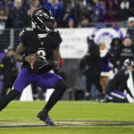 Dec 21, 2025; Baltimore, Maryland, USA; Baltimore Ravens quarterback Lamar Jackson (8) looks to pass against the New England Patriots during the first quarter of the game at M&T Bank Stadium. Mandatory Credit: James Lang-Imagn Images