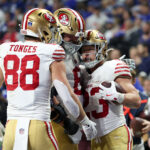 Dec 22, 2025; Indianapolis, Indiana, USA; San Francisco 49ers running back Christian McCaffrey (23) celebrates after scoring a touchdown against the Indianapolis Colts with tight end Jake Tonges (88) and fullback Kyle Juszczyk (44) in the fourth quarter of the game at Lucas Oil Stadium. Mandatory Credit: Trevor Ruszkowski-Imagn Images