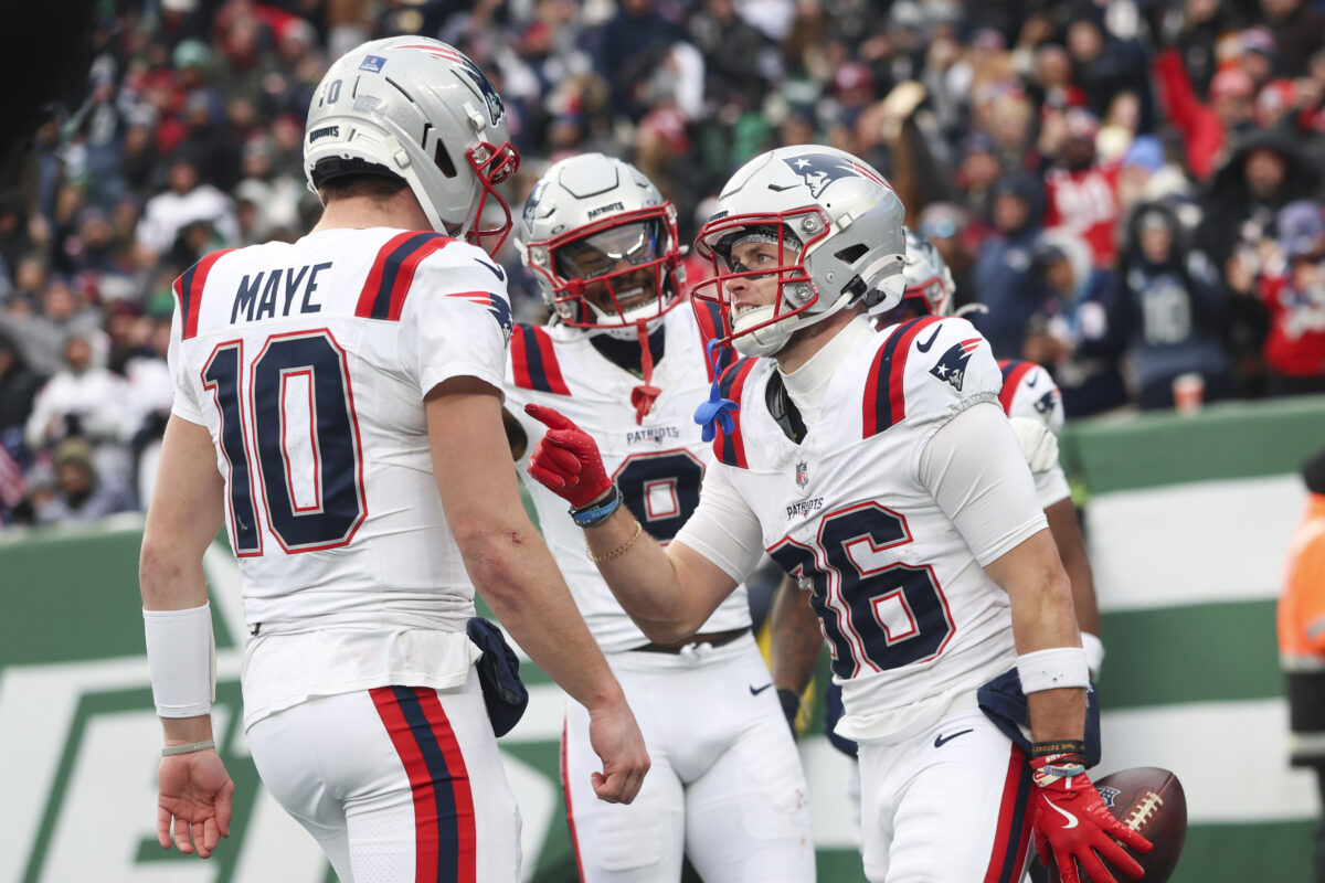 Dec 28, 2025; East Rutherford, New Jersey, USA; New England Patriots wide receiver Efton Chism III (86) celebrates his touchdown catch against the New York Jets with New England Patriots quarterback Drake Maye (10) during the second half of the game at MetLife Stadium. Mandatory Credit: Vincent Carchietta-Imagn Images