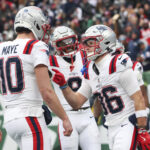 Dec 28, 2025; East Rutherford, New Jersey, USA; New England Patriots wide receiver Efton Chism III (86) celebrates his touchdown catch against the New York Jets with New England Patriots quarterback Drake Maye (10) during the second half of the game at MetLife Stadium. Mandatory Credit: Vincent Carchietta-Imagn Images