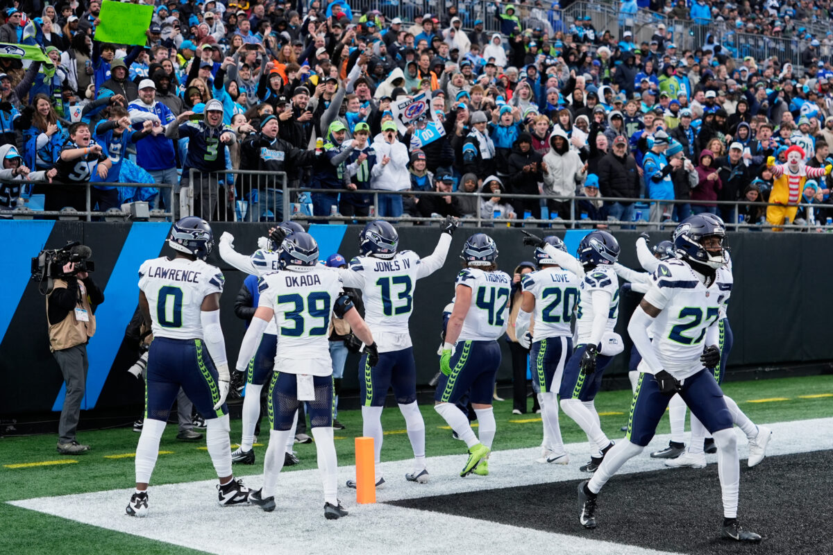 Dec 28, 2025; Charlotte, North Carolina, USA; Seattle Seahawks linebacker Ernest Jones IV (13) celebrates with teammates after recovering a fumble against the Carolina Panthers during the third quarter at Bank of America Stadium. Mandatory Credit: Jim Dedmon-Imagn Images