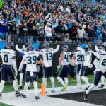 Dec 28, 2025; Charlotte, North Carolina, USA; Seattle Seahawks linebacker Ernest Jones IV (13) celebrates with teammates after recovering a fumble against the Carolina Panthers during the third quarter at Bank of America Stadium. Mandatory Credit: Jim Dedmon-Imagn Images